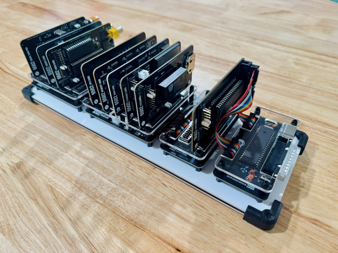 A backplane seen from the side with about a dozen cards standing upright in its slots, each labeled along its top edge.