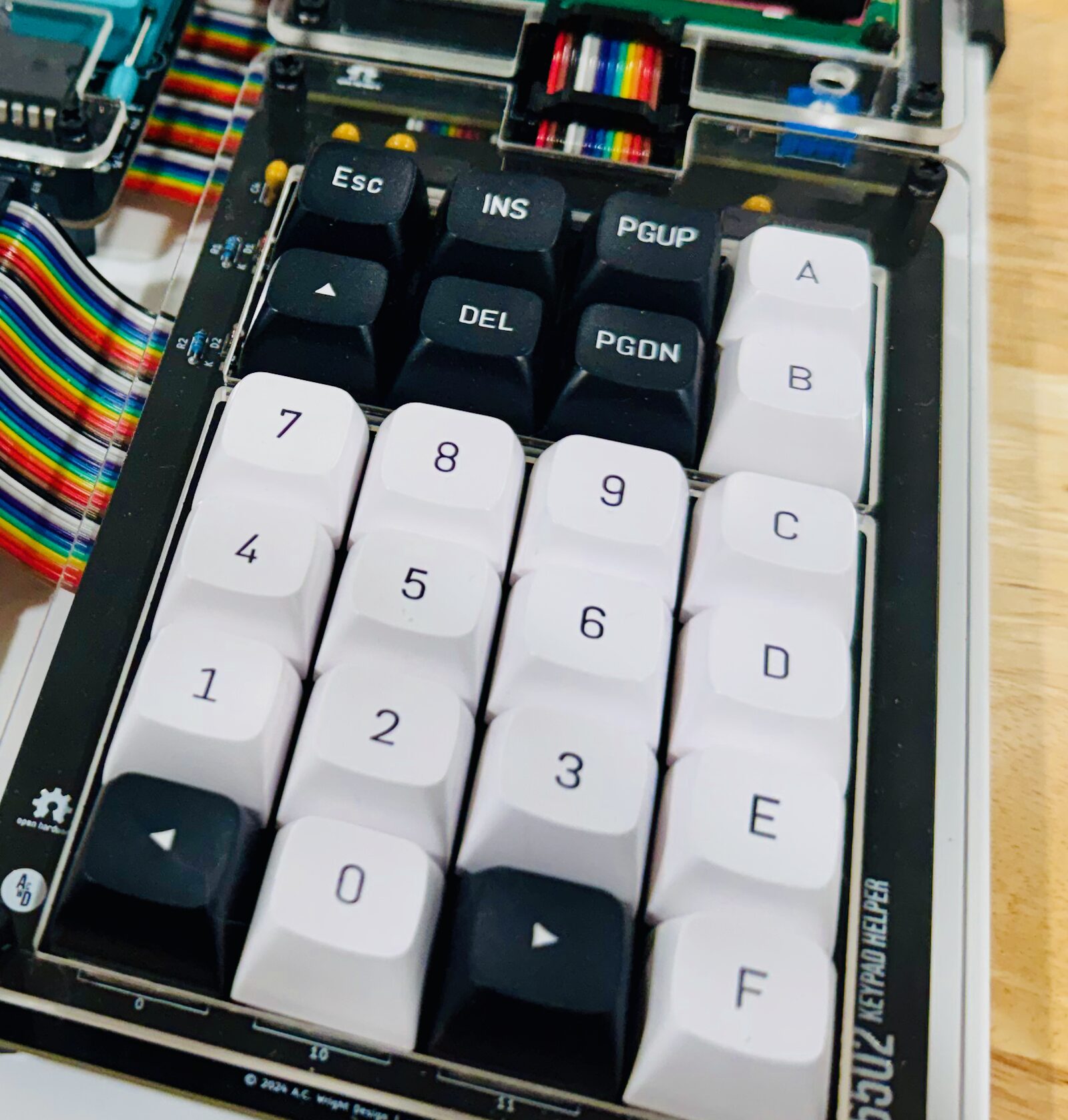 A close-up of the keypad: sixteen white keys numbered 0 to 9 and A to F, with dark Esc, INS, DEL, PGUP, PGDN and arrow keys around them.